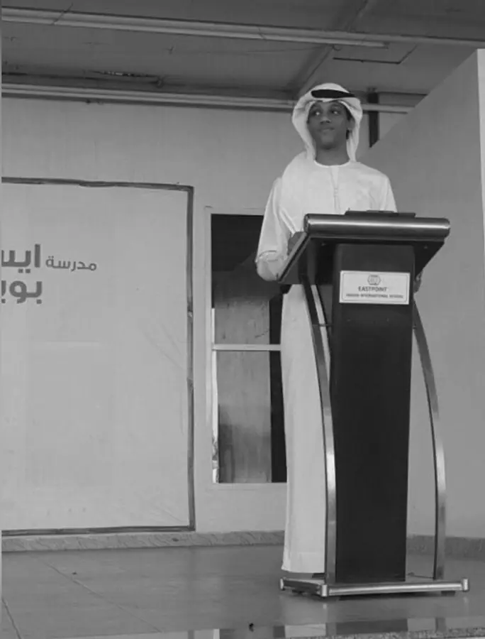 Muhammed Shafad speaking at a school podium as head boy in the UAE